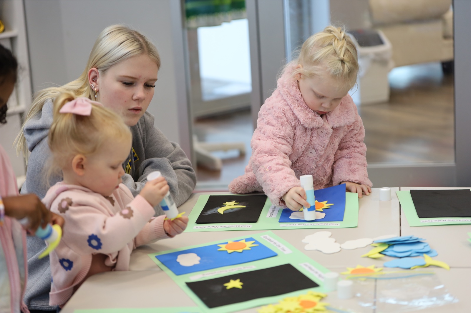 Young children making crafts at Agape Kids
