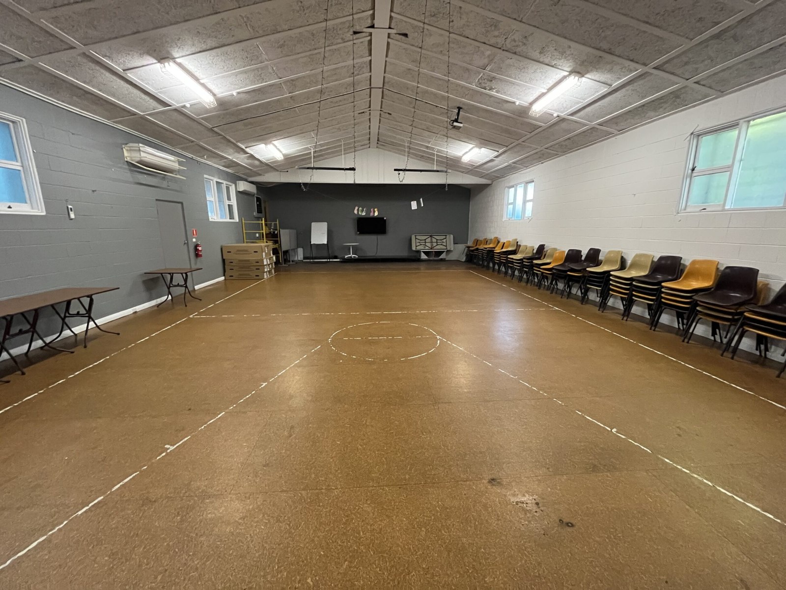 The church hall with an open floor, chairs and tables
