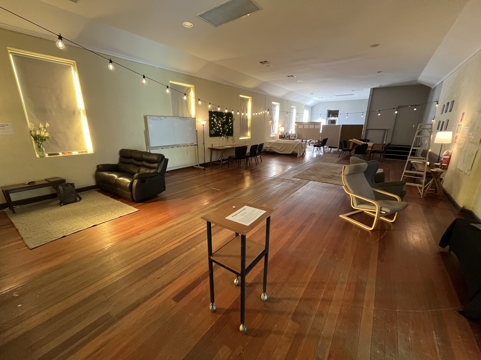The foyer with seating, a coffee area and an open timber floor